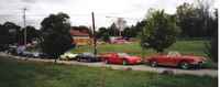 Shows/2004 - Lake Geneva Poker Run/Fiero and vettes parked in line side view.jpg